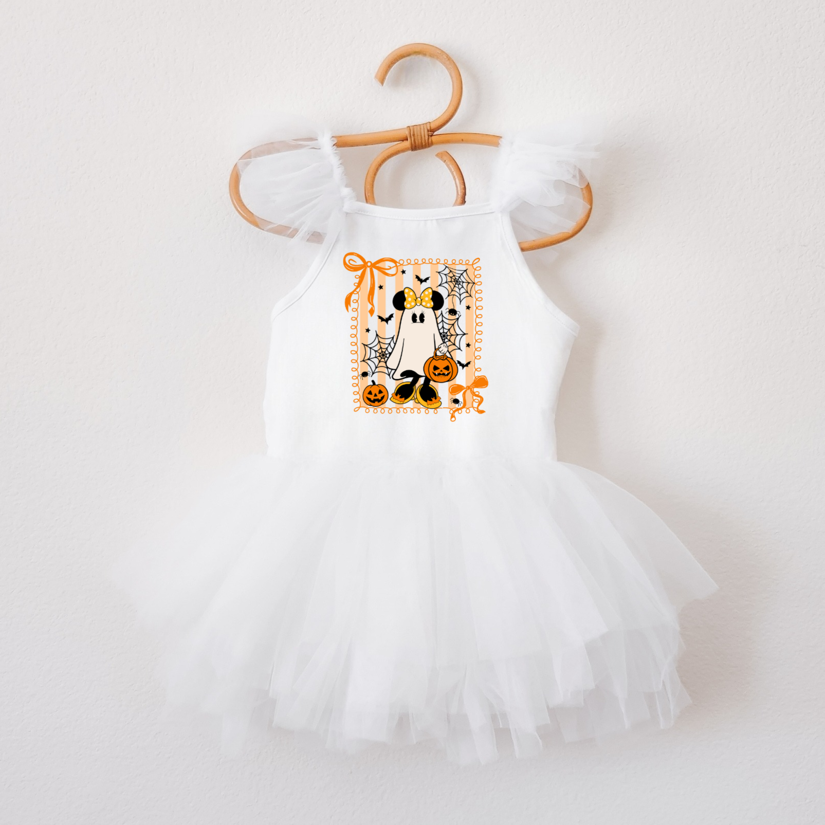 White baby romper with Halloween design on a hanger against a white background