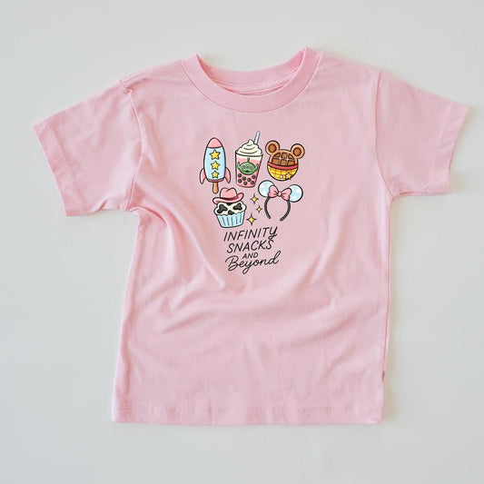 Pink kids' t-shirt with "Infinity Snacks and Beyond" text and cartoon snacks like a rocket, boba, and The-shaped treats.