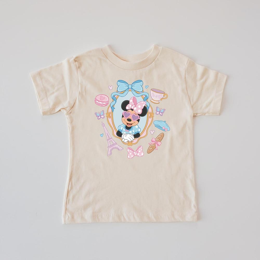 Beige unisex T-shirt with a "Miss Mouse in Paris" design featuring The Mouse, Eiffel Tower, and macarons.