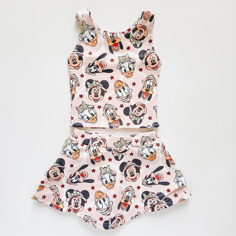 Kids' pink activewear two-piece with The, The, Ducky, and Pluto safari print.