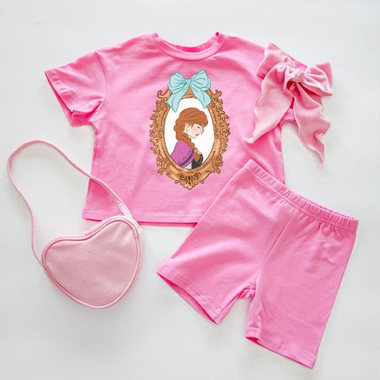 Pink cotton Anna Biker Set: short-sleeve top with Anna portrait, biker shorts, heart purse, and bow.