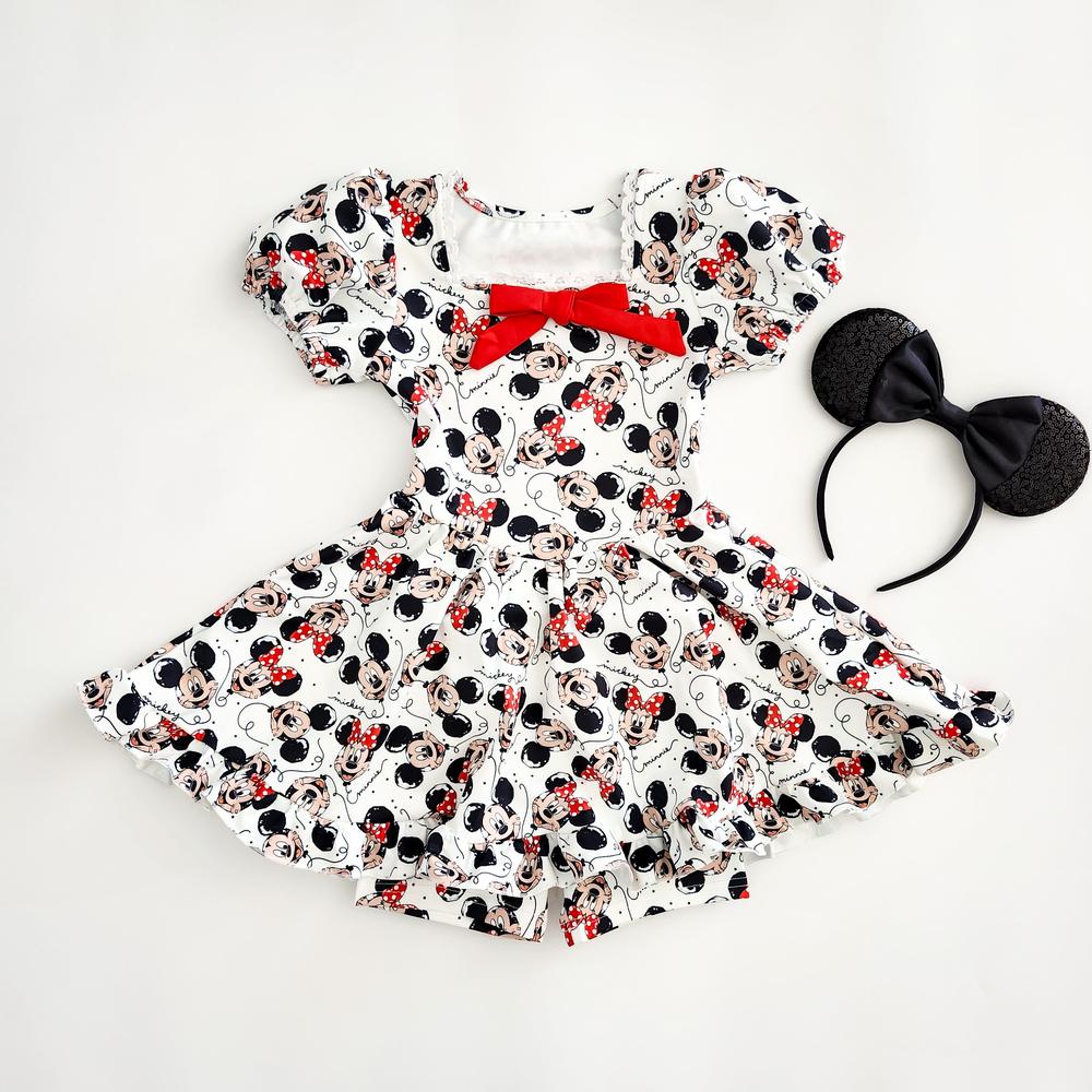 White activewear dress and detached biker shorts with The Mouse print, red bow, and matching The ears.