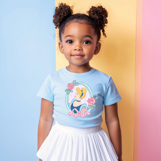 Young girl in a light blue Cinderella t-shirt with pink roses, paired with a white pleated skirt.