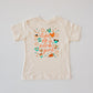 Cream t-shirt with "Life of a park girl" text and colorful The Park-themed icons.
