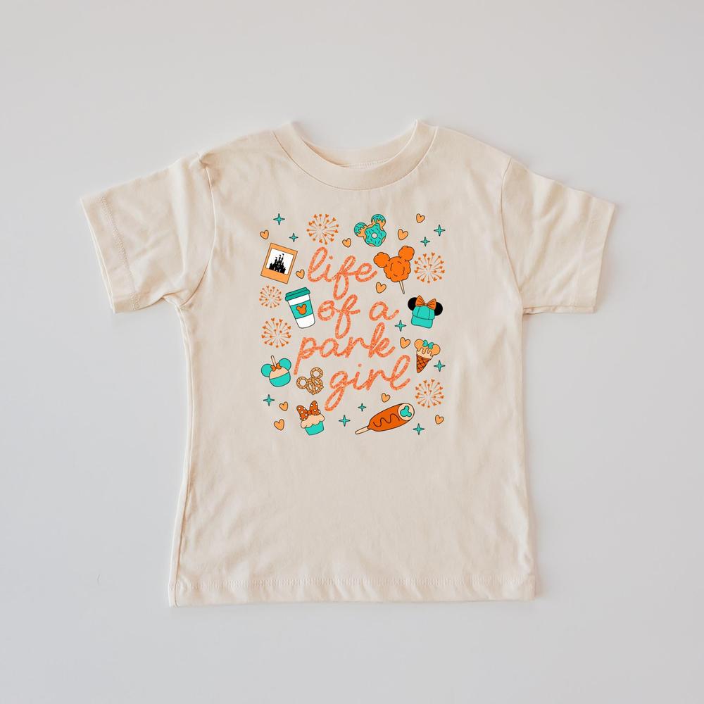 Cream t-shirt with "Life of a park girl" text and colorful The Park-themed icons.