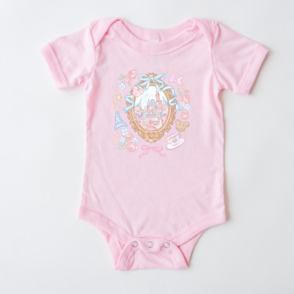 Pink baby onesie with a magical coquette castle, floral, and princess-themed design.