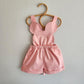 Pink mouse-inspired cotton-spandex shorts overalls with stretch waistband and bow-tie straps.