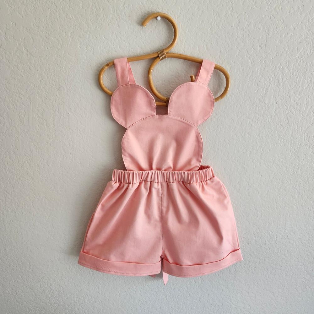 Pink mouse-inspired cotton-spandex shorts overalls with stretch waistband and bow-tie straps.