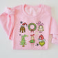 Pink sweatshirt with Christmas-themed cartoon characters on a white background