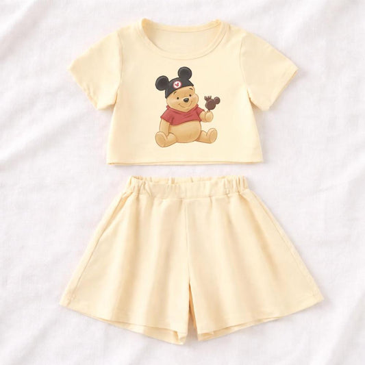 Light yellow cotton Winnie the Pooh two-piece set with crop top and flare leg shorts.