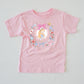 Pink cotton Wonderland Kids & Adult T-shirt with Alice in a floral frame, playing cards, and teacups.