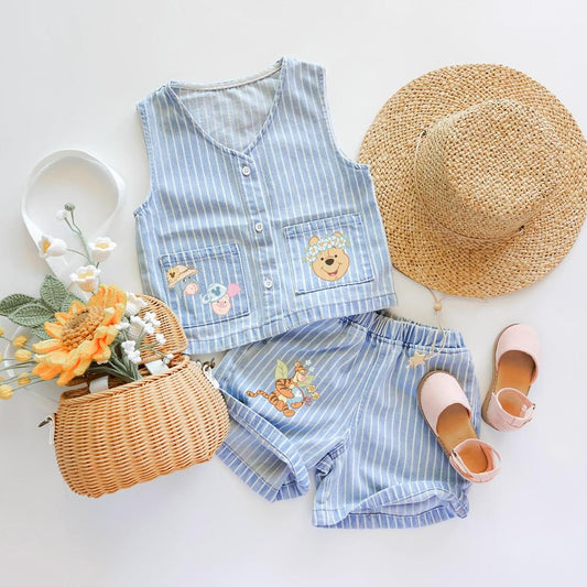 Light blue striped denim vest and shorts set with Winnie the Pooh characters, straw hat, basket, and pink sandals.
